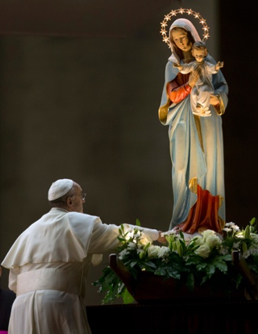 Pope Francis pays homage to a statue of the Virgin Mary during a ceremony to mark the closure of the month dedicated to the Virgin Mary, in St. Peter